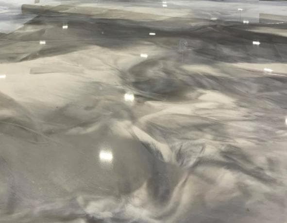 High-gloss metallic epoxy floor in a Wanneroo living space with marbled effect